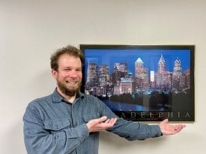 Staff Attorney Mike stands in front of Philadelphia Poster